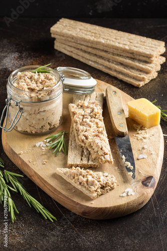 Tuna pate with egg, cheese in jar and crispy bread. Fish rillette, healthy snack, diet food