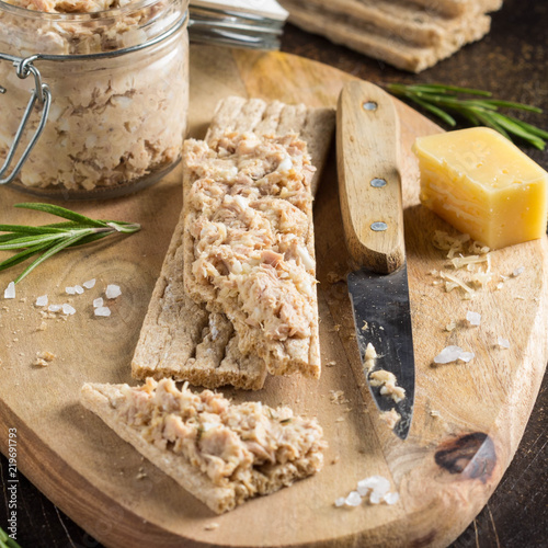Tuna pate with egg, cheese in jar and crispy bread. Fish rillette, healthy snack, diet food