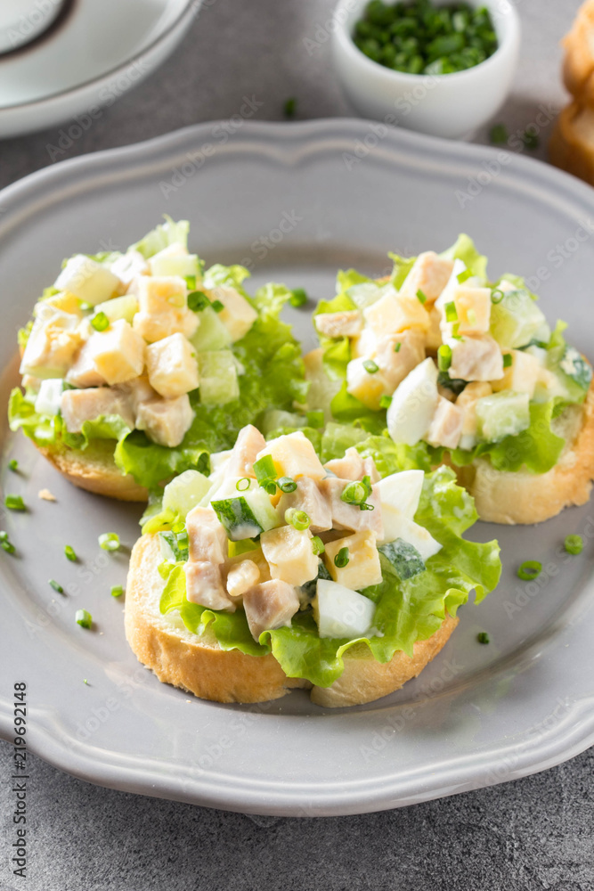 Sandwiches with squid meat salad, cucumber, egg, cheese and mayonnaise.  Canapes in tartlets, Russian snack. Delicious food for Breakfast Stock  Photo | Adobe Stock