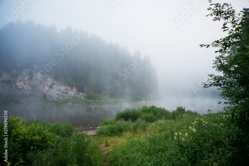Natural background, landscape: morning fog on the river in the forest, at dawn on a summer day. Soft focus. © malykalexa777