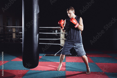 Boxer training on a punching bag in the gym