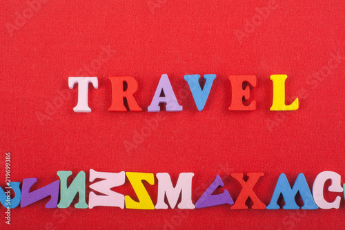 TRAVEL word on red background composed from colorful abc alphabet block wooden letters, copy space for ad text. Learning english concept.