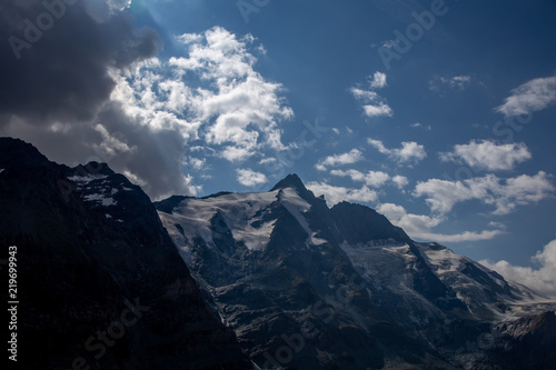 Dramatic sky in a valley with a mountain Grossglockner