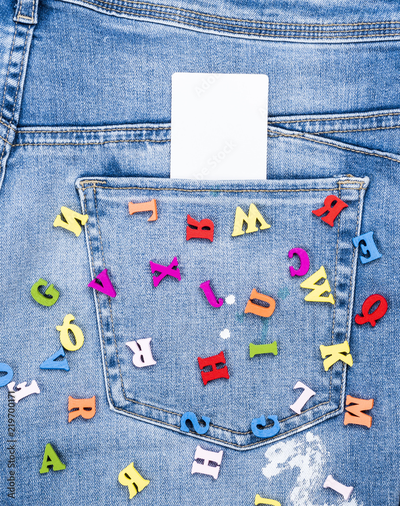 colored wooden letters scattered on blue jeans Stock Photo | Adobe Stock