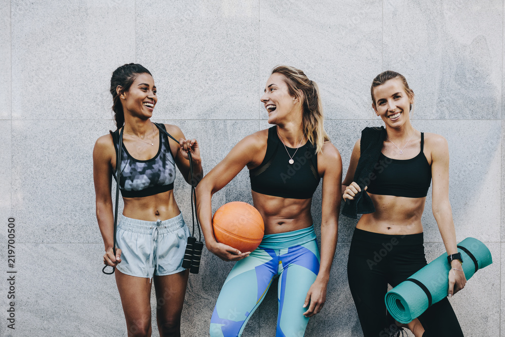 Smiling fitness women standing outdoors after workout - obrazy, fototapety, plakaty 