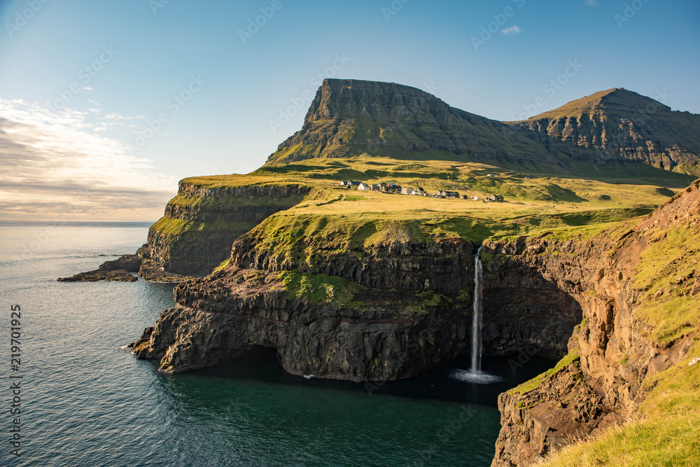 Ταπετσαρία Gásadalur is a village located on the west side of Vágar, Faroe Islands, and enjoys a panoramic view over to the island of Mykines