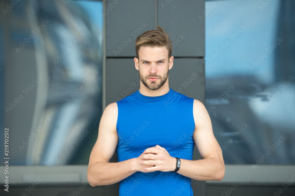 Fototapeta premium Feeling ready to start. Guy bearded attractive appearance holds hands nervous gesture. Man hipster bristle strict face urban background. Man with beard set up mind confident to start training