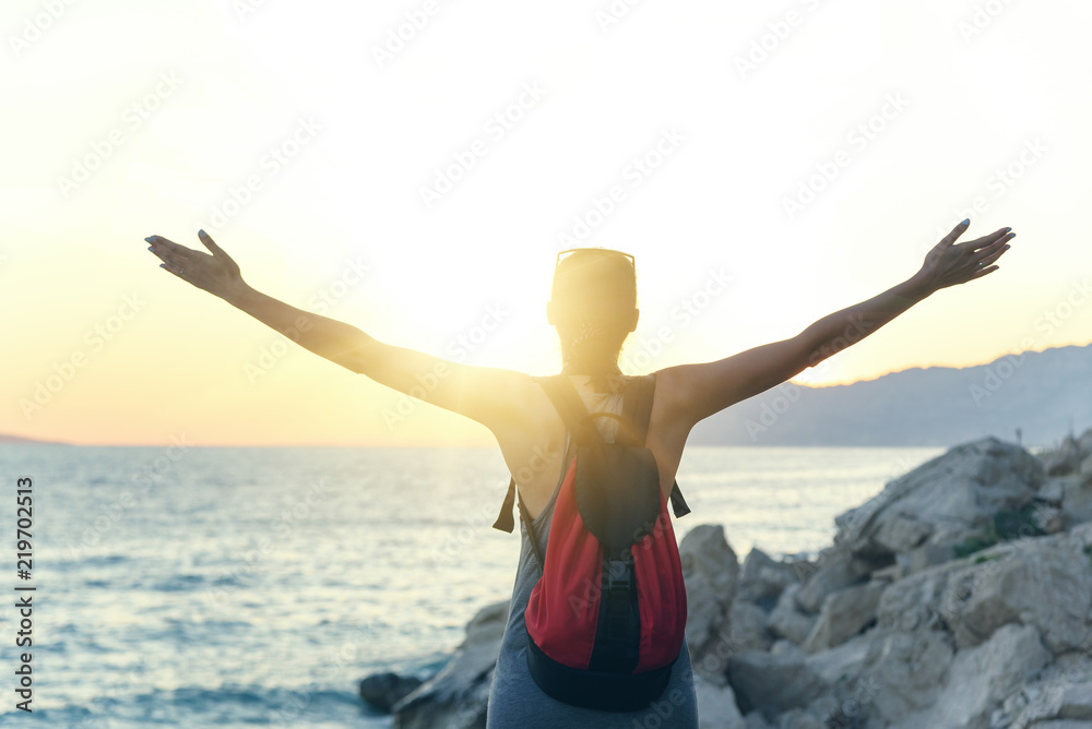 Young woman on the beach at sunset. Young woman on the beach at sunset.