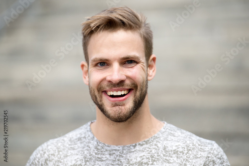 Man with perfect brilliant smile unshaven face defocused background. Guy happy emotional expression outdoors. Bearded and handsome. Man happy smiling face white brilliant teeth. Dentistry concept