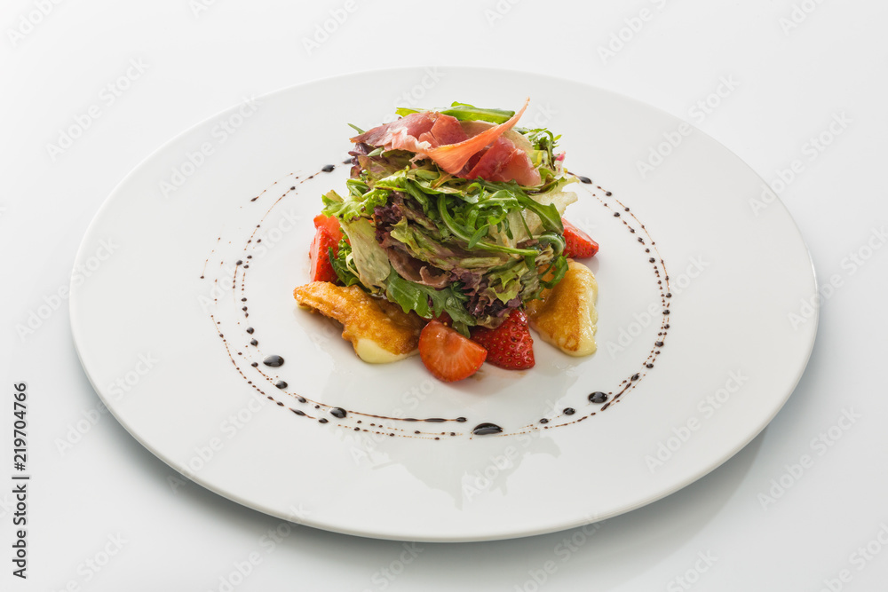 salad with jamon, strawberries and greens isolated on white background salad with jamon, strawberries and greens isolated on white background