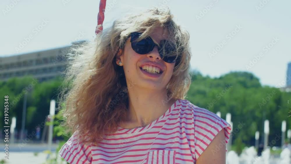 Curly girl on a swing in a summer park. Curly girl on a swing in a summer park.