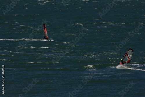 two sailboarders skim across the waters of San Francisco Bay, summer, 2018