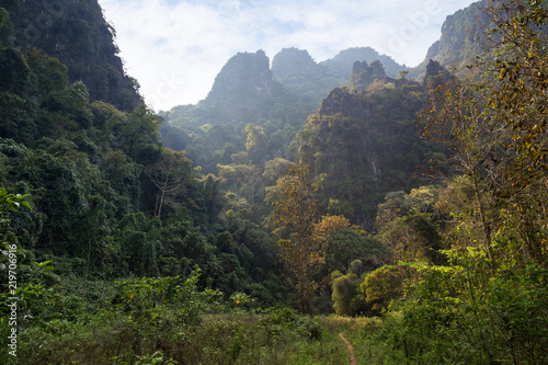 Scenic view of lush nature, limestone mountains and hills near Vang Vieng, Vientiane Province, Laos, on a sunny day.