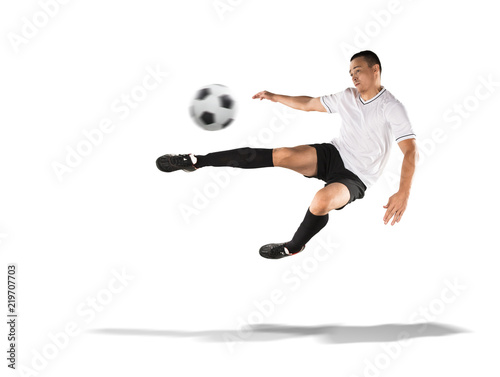 soccer player kicking the ball in the air isolated on white © 27mistral