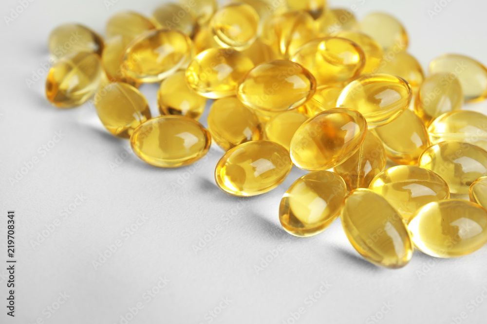 Cod liver oil pills on light background, closeup Cod liver oil pills on light background, closeup