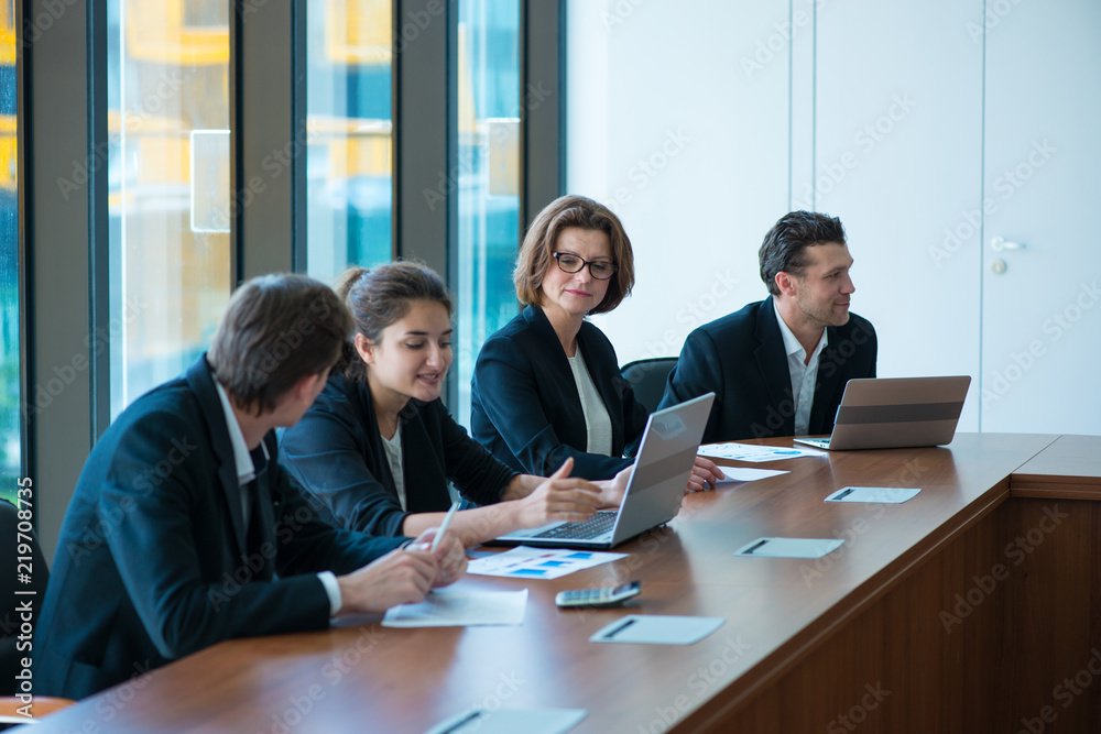 Business partners discussing documents Business partners discussing documents