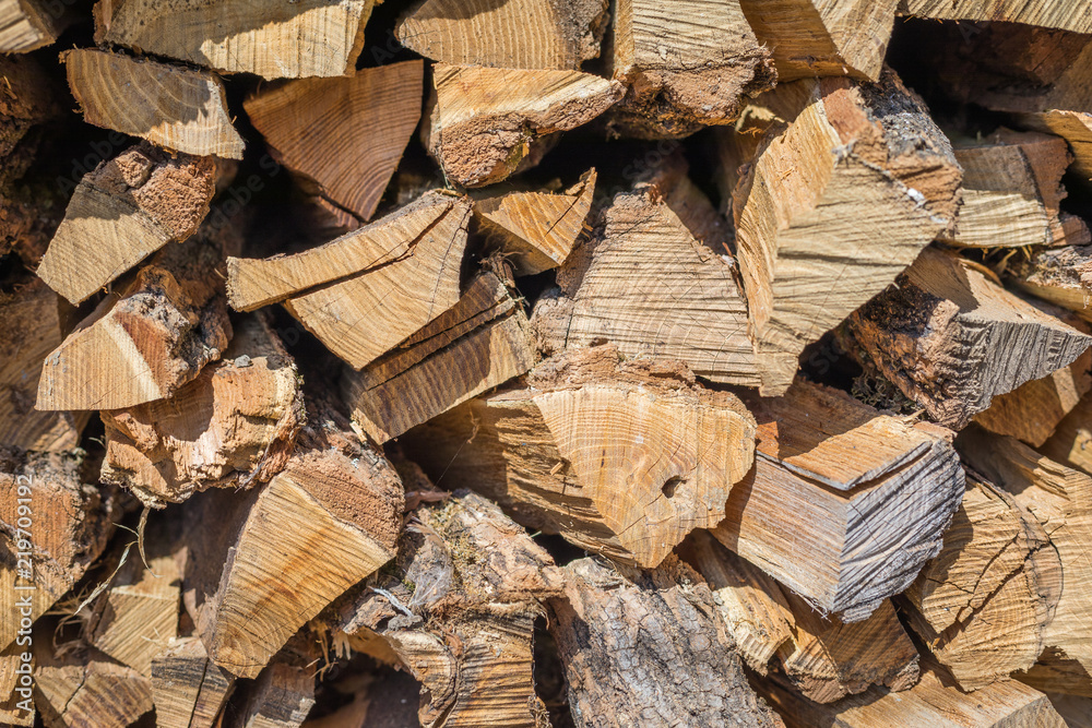 Cut wood, firewood for the winter. Cut logs fire wood and ready pieces of wood for heating wood. Lumber industry. Heating season, winter season. Renewable resource of energy. Environmental concept. Cut wood, firewood for the winter. Cut logs fire wood and ready pieces of wood for heating wood. Lumber industry. Heating season, winter season. Renewable resource of energy. Environmental concept.