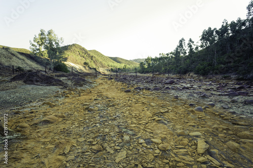 Dry riverbed with orange stones