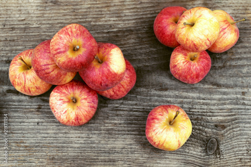 fresh red apples lie on a wooden board. harvesting