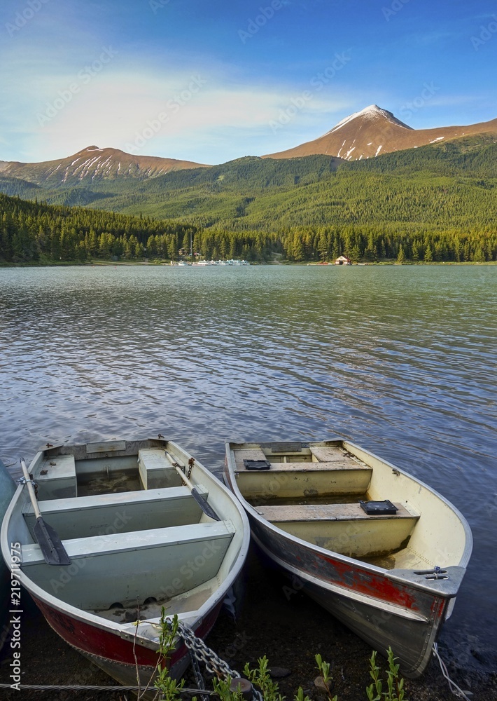 Canoe Boats on Maligne Lake with Distant Canadian Rocky Mountain Peaks of Jasper National Park on the Horizon