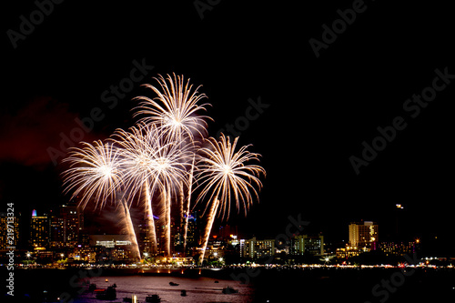 Many flashing fireworks with night cityscape background celebrate New Year. © N_studio