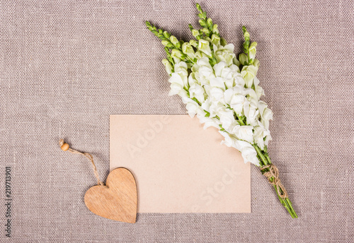 Empty sheet of paper and white flowers. Romantic love letter. Romantic background. Copy space