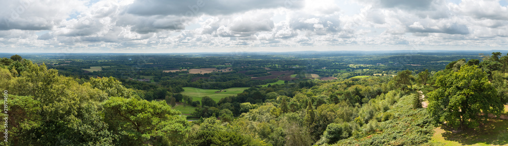Panoramic view of the Surrey and Sussex countryside from the North Downs to the South Downs in England, UK. Taken from the top of Leith Hill Tower on a cloudy summer's day.