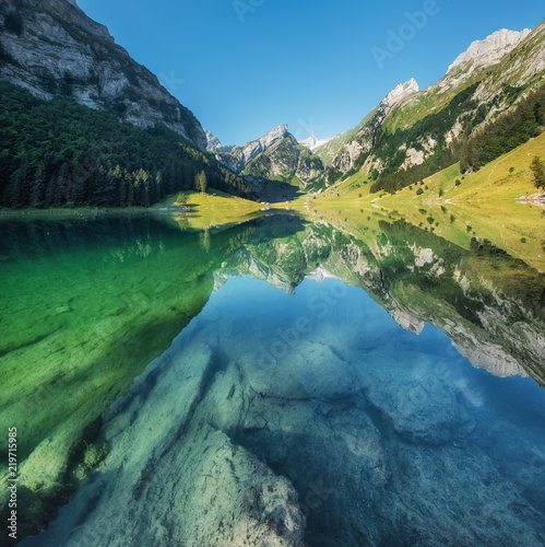 Mountains and lake in the Switzerland. Reflection on the water surface. Natur...