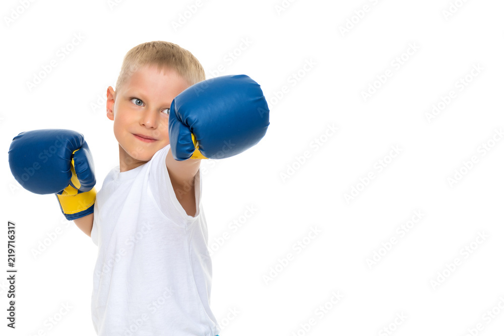 A little boy in a clean white T-shirt and boxing gloves. A little boy in a clean white T-shirt and boxing gloves.