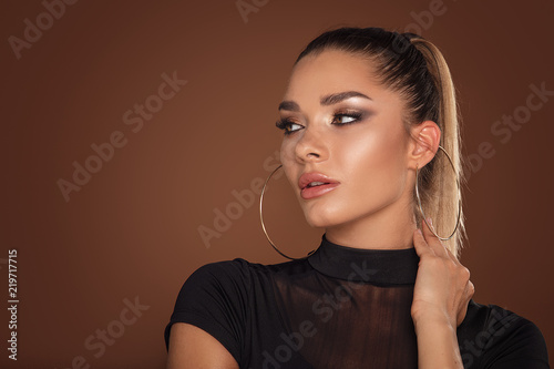 Face of attractive woman in golden makeup.