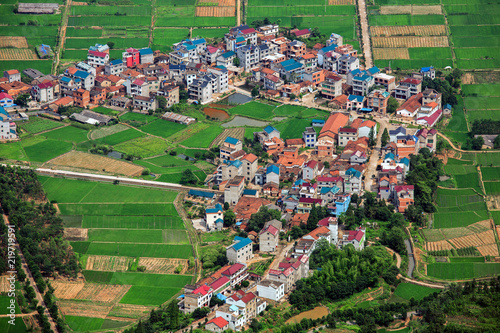 Colorful Chinese Village and farmland near Jianglangshan Scenic Area, Mount Jianglang - Quzhou, Zhejiang Province China. Unesco World Heritage, Danxia Landform, China Danxia Scenic Area. Green Fields photo