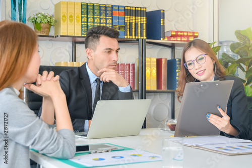 Financial report analysis and reviewing concept :CFO or chief financial officer sees financial summary reports with his secretary team and discusses about future growth and improvements
