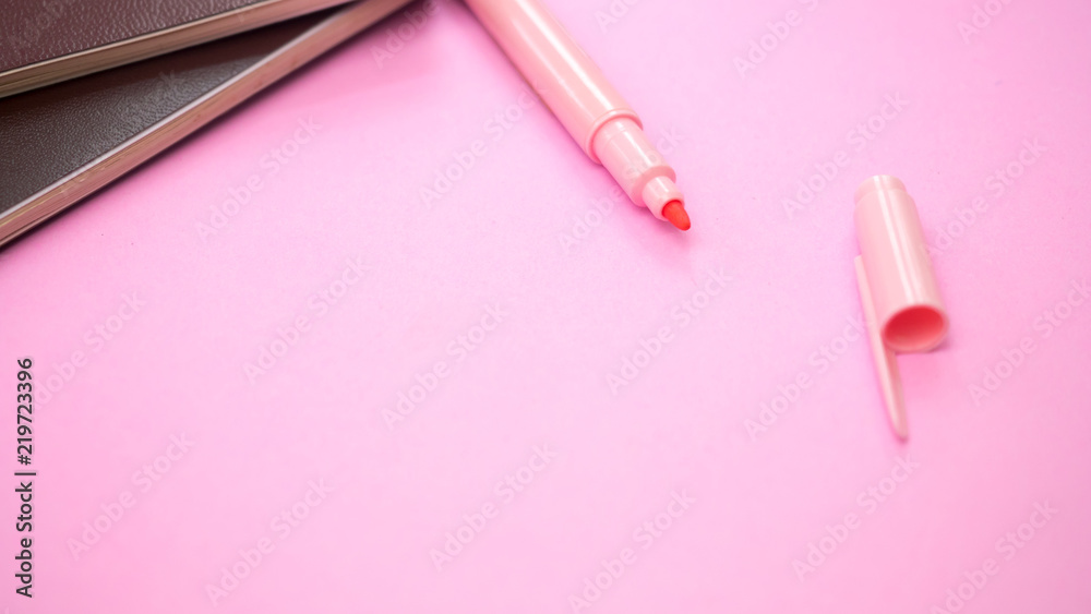 Magic pen with book on pink background.Close up Magic pen with book on pink background.Close up