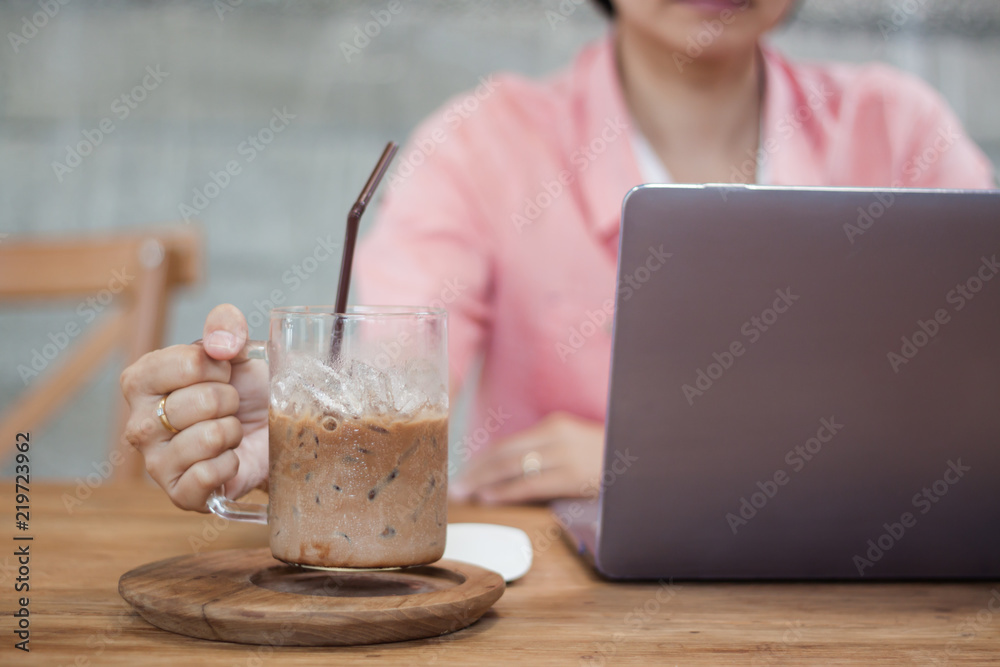Woman working on computer in coffee shop Woman working on computer in coffee shop