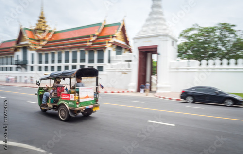 Photography Bangkok / Thailand - 8-10-2017: green tuc tuc taxi driving tourists around in th