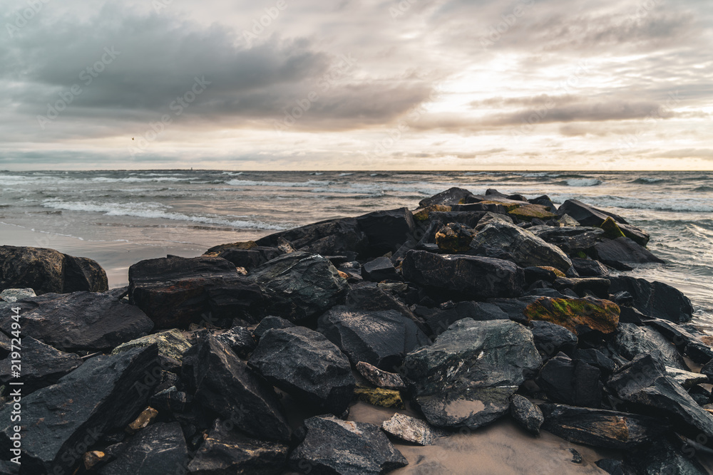 Rockwall in Ocean With Crashing Water at Sunrise Landscape Rockwall in Ocean With Crashing Water at Sunrise Landscape