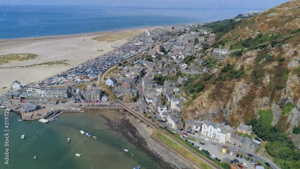 Aerial view, forward move. Drone panorama over sea, harbor, beach and old town of Barmouth, Wales Aerial view, forward move. Drone panorama over sea, harbor, beach and old town of Barmouth, Wales