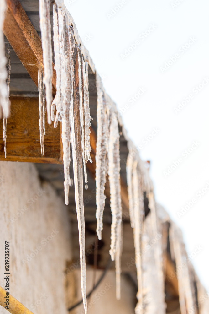 icicles hanging from the roof or pipes in winter icicles hanging from the roof or pipes in winter
