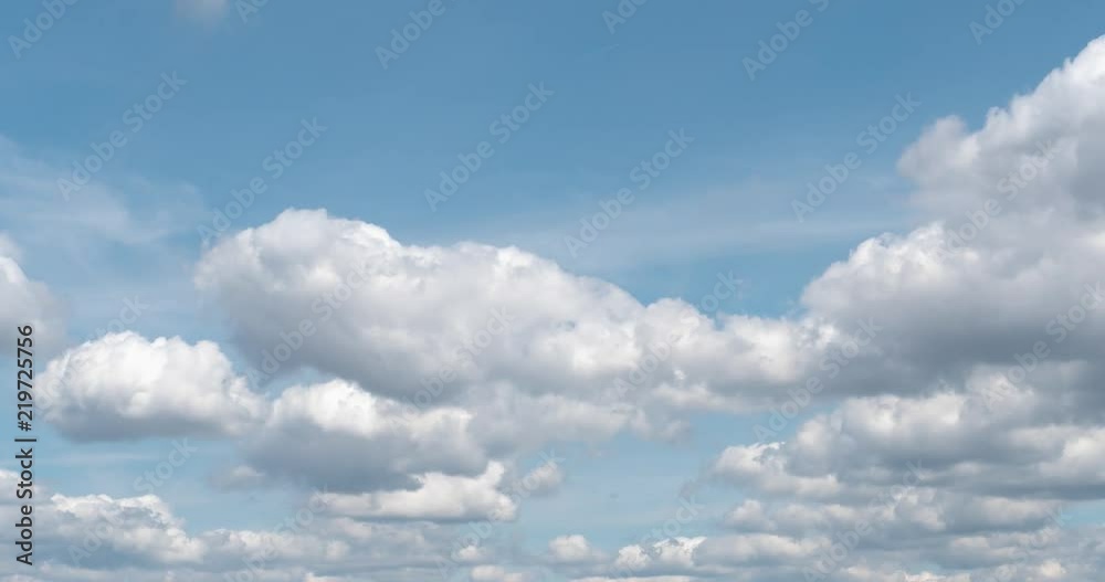 White Puffy Clouds Drifting Across Blue Sky in Time Lapse White Puffy Clouds Drifting Across Blue Sky in Time Lapse