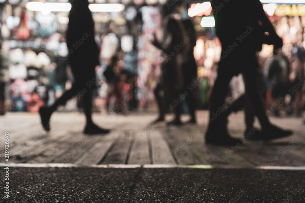 People Walking On Wildwood New Jersey Boardwalk at Night with Apparel store in Background and Man Walking in Sandals in Foreground People Walking On Wildwood New Jersey Boardwalk at Night with Apparel store in Background and Man Walking in Sandals in Foreground