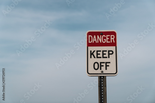 Danger Keep off Sign with Blue Cloudy Sky and New Jersey Beach in the Background