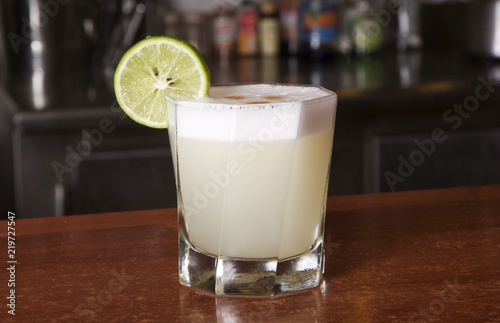Peruvian cocktail called Pisco Sour made of Pisco Peruvian grape schnaps , lime juice, syrup, egg white, and some angostura bitter drops on top