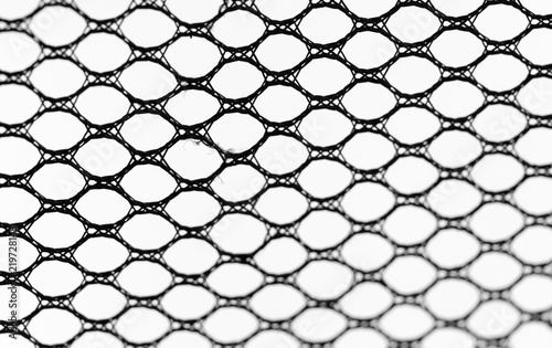 background, black synthetic fabric with holes