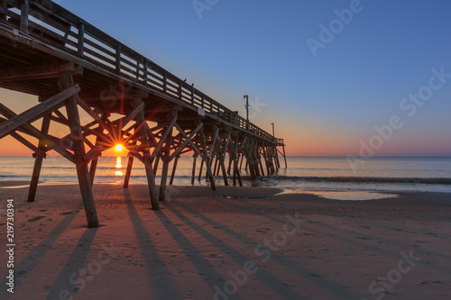 Sun shining through the pilings of Myrtle Beach Pier