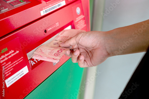 Hand of a man using an ATM about Financial Transactions.
