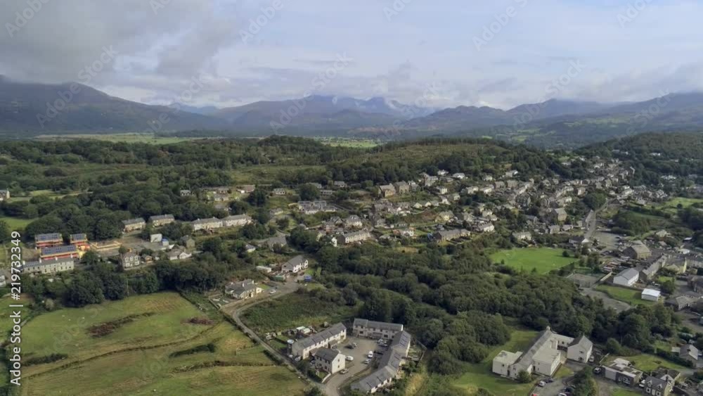 Aerial view, landing, down move. Drone panorama of Penrhyndeudraeth town in Snowdonia mountains in Wales Aerial view, landing, down move. Drone panorama of Penrhyndeudraeth town in Snowdonia mountains in Wales