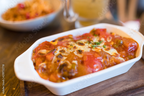 Enjoy baked tomato sauce riced with cheese inside restaurant