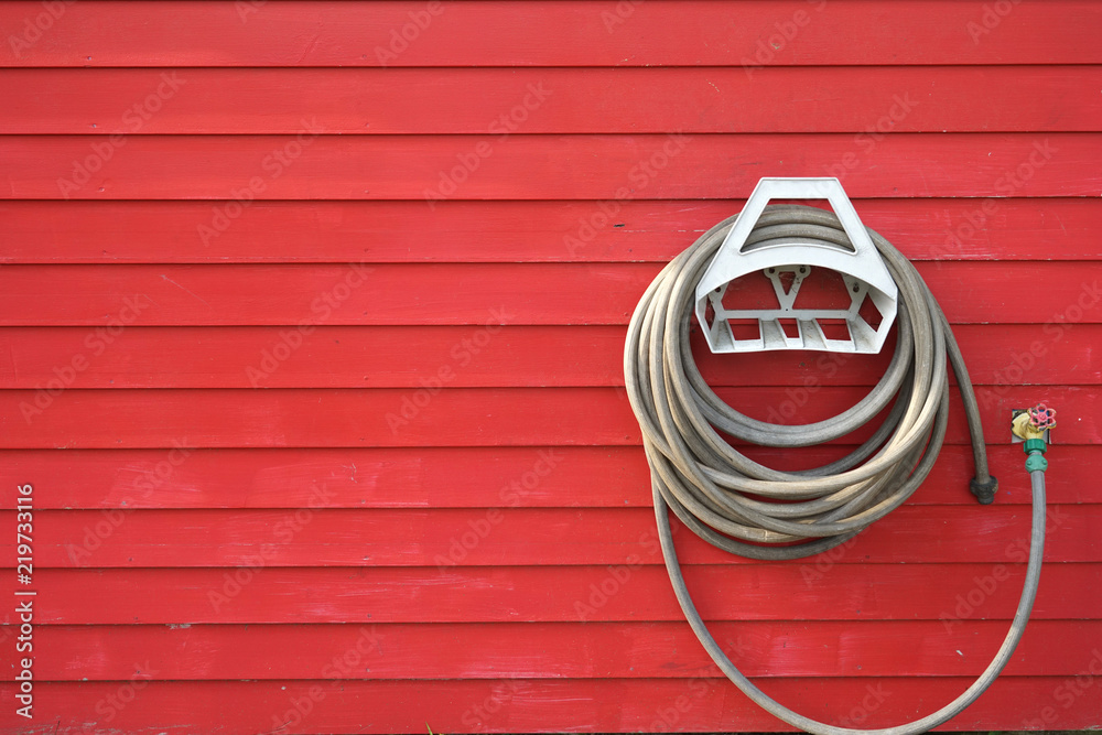 background of garden hose reel mounted on the wall background of garden hose reel mounted on the wall