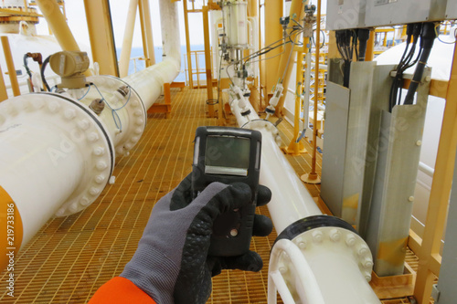 Personal H2S Gas Detector,Check gas leak. Safety concept of safety and security system on offshore oil and gas processing platform, hand hold gas detector.