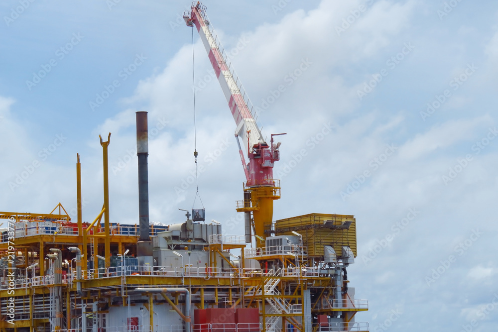Crane construction on Oil and Rig platform for support heavy cargo. Transfer cargo or basket on work site, Heavy industry, heavy job on the oil and gas platform, Offshore operation on the platform. Crane construction on Oil and Rig platform for support heavy cargo. Transfer cargo or basket on work site, Heavy industry, heavy job on the oil and gas platform, Offshore operation on the platform.
